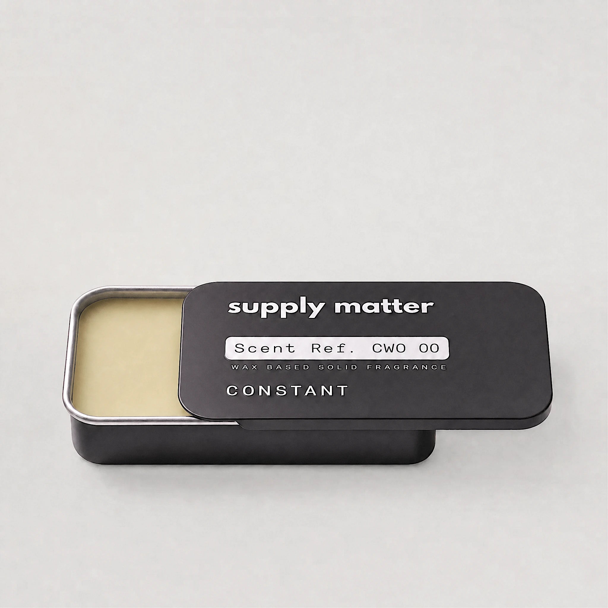 CONSTANT solid cologne tin, angled side view
