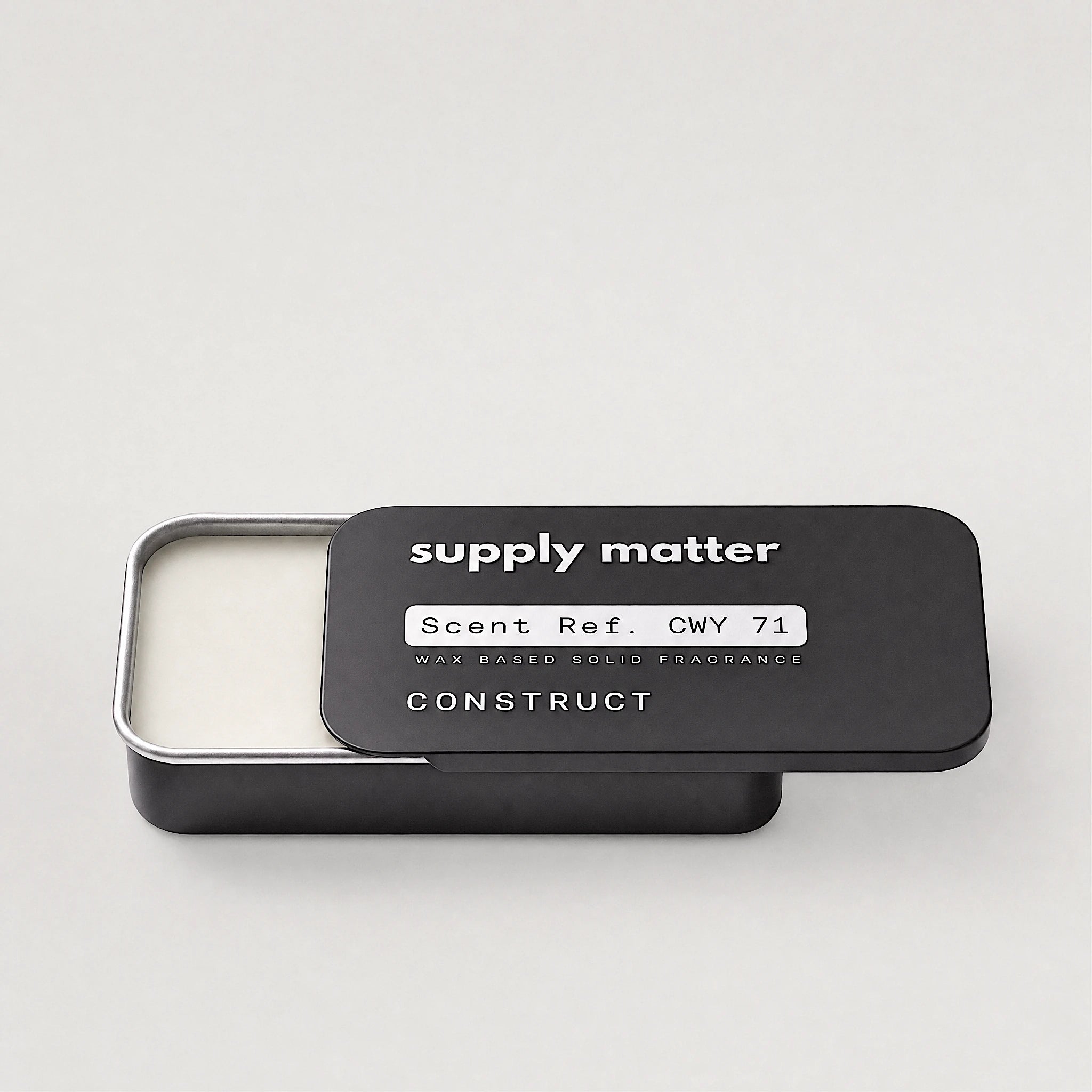 CONSTRUCT solid cologne tin, angled side view