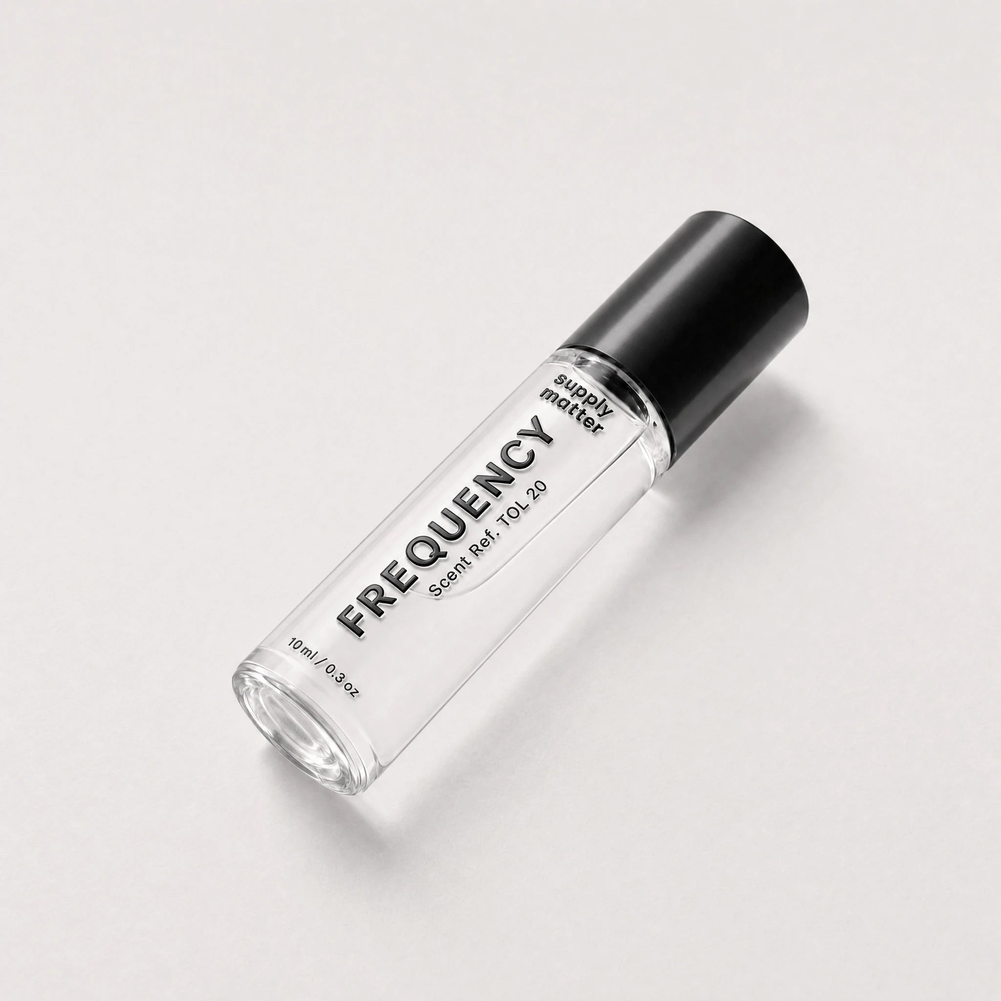 FREQUENCY liquid cologne bottle, angled side view