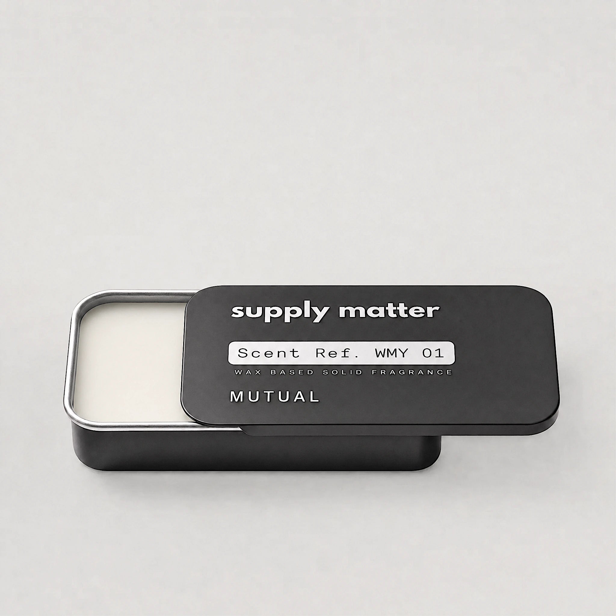 MUTUAL solid cologne tin, angled side view
