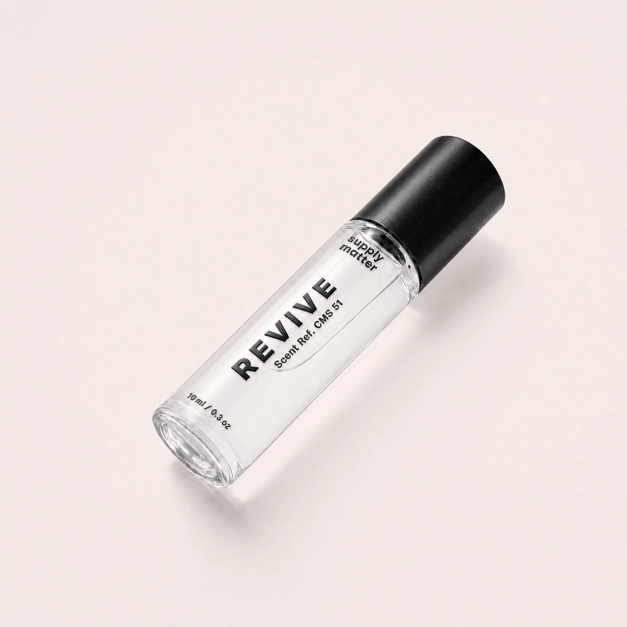 REVIVE liquid cologne bottle, angled side view