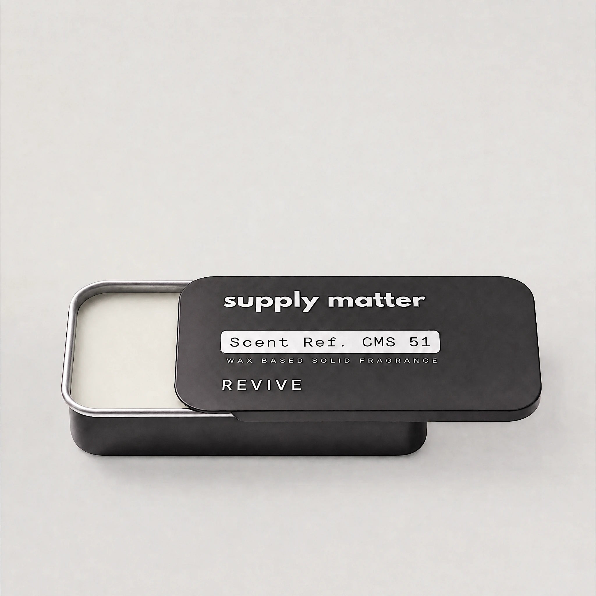 REVIVE solid cologne tin, angled side view